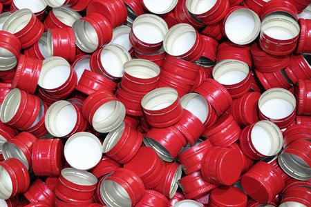 Pile of bottle red metal screw caps as pattern backgroundの写真素材
