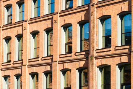 Old industrial building from red bricks with metal rain pipes