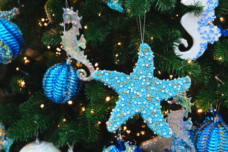 Close-up of blue colored star shaped and blue colored christmas toys on the Christmas treeの写真素材