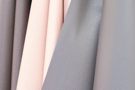 Mix colorful hanging vertical stripe leather on the rack. Texture of multicolored leather close up.の写真素材