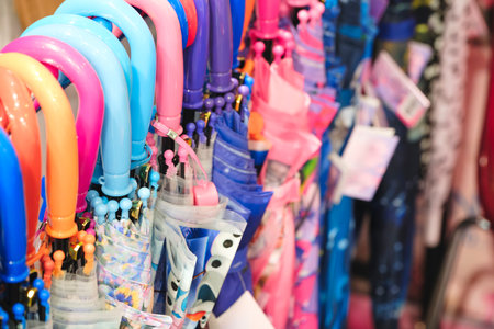 Different umbrellas hanging on rack in supermarketの写真素材