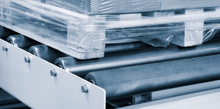 Cardboard boxes on a pallet wrapped in plastic wrap ready for delivery in a warehouse, logistics warehouse delivery concept backgroundの写真素材