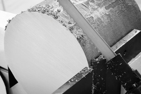 The automatic band saw machine cutting the metal bar with coolant method. The machine tool for industrial purpose.の写真素材