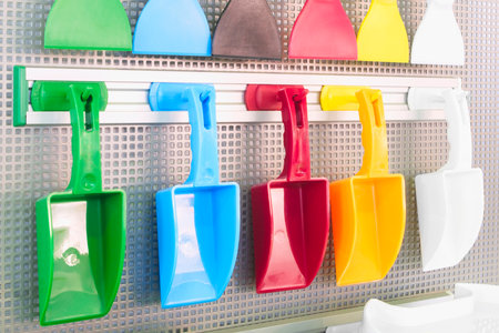 dustpans for cleaning an apartment and office in a rack in a store, cleaning concept backgroundの写真素材