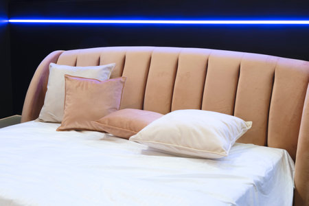 Interior of a modern bedroom in an apartment, hotel or private house with a bed and pillowsの写真素材