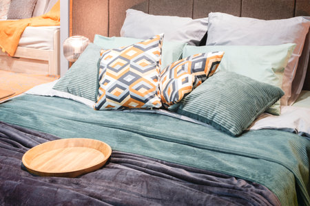 Interior of a modern bedroom in an apartment, hotel or private house with a bed and pillowsの写真素材