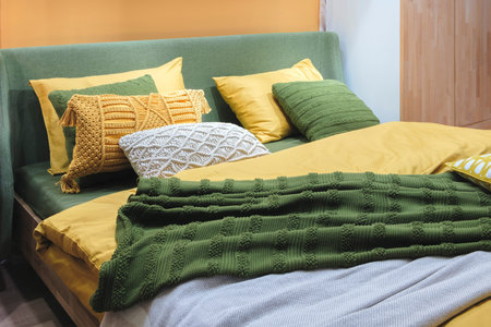 Interior of a modern bedroom in an apartment, hotel or private house with a bed and pillows