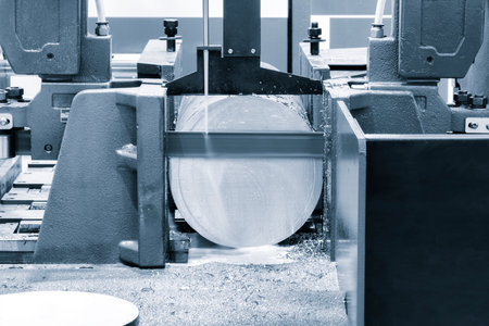 The automatic band saw machine cutting the metal bar with coolant method. The machine tool for industrial purpose.の写真素材