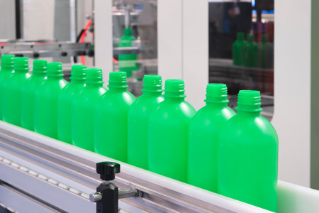 pharmaceutical industry, medicine pills are filling in the bottle on production line machine conveyor at the medical factory. selective focus.の写真素材