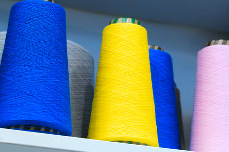 Spools of color threads closeup for spinning machineの写真素材