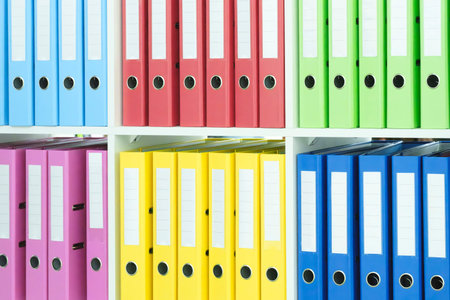 Multi-colored file folders on business office shelves, document archive, accounting or reports...