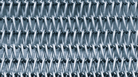 A close up of a metal chain with many small links. The chain is silver and has a metallic lookの写真素材