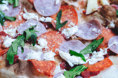 A pizza with pepperoni and cheeseの写真素材