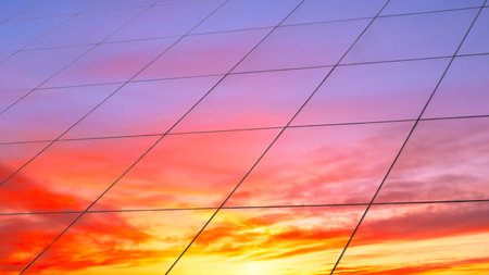 Web banner Modern glass architecture with reflection of red and blue sunset sky. Dramatic bright...