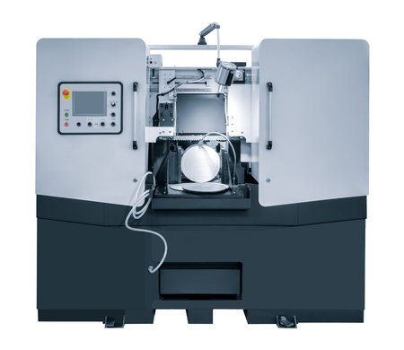 The automatic band saw machine cutting the metal bar with coolant method. The machine tool for...