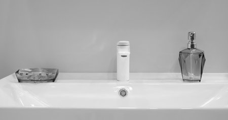 A sink with a soap dispenser and a toothbrush holderの写真素材