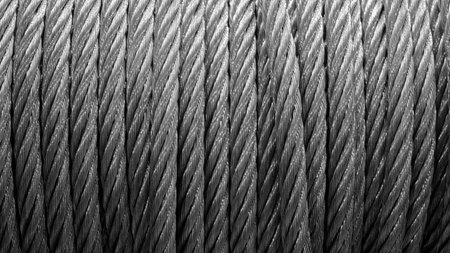 Metal tow rope wound on a winch as a texture background