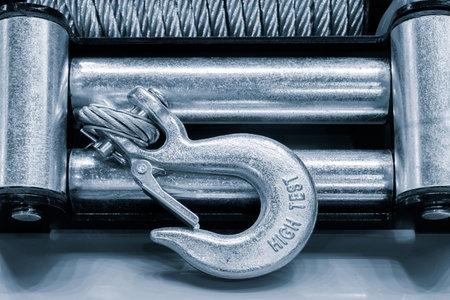 A hook is attached to a metal bar. The hook is labeled High Light. The hook is silver and has a...