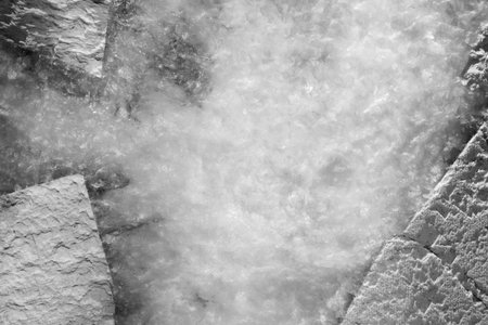 A blurry image of a body of water with a white background. The water appears to be frozen, and the...