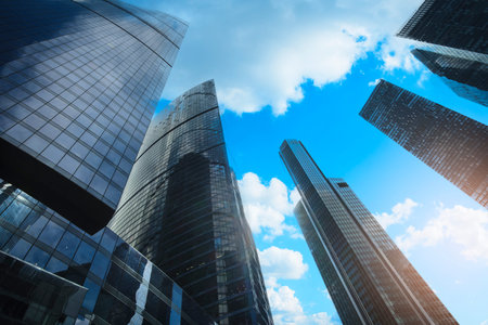Tall office skyscrapers with sky reflection in windows, business concept banking background