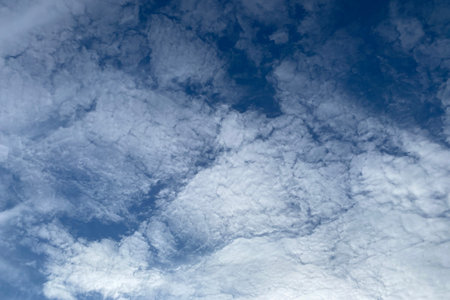 The sky is blue and filled with clouds. The clouds are scattered throughout the sky, with some...