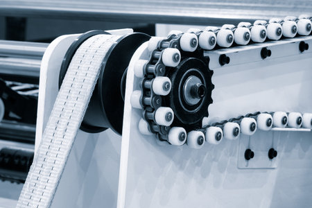 Part of a modern roller conveyor with metal and plastic rollers for the production of various products, industrial concept background.の写真素材