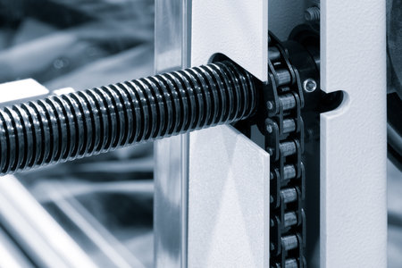 Gear chain drive shaft in conveyor belt is on production line. Timing chain of car, tensioners in engine. Industrial roller chain technology. Team work, business industrial conceptの写真素材