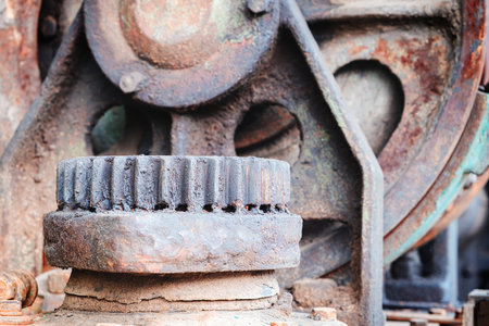 A rusty old machine with a worn out gear. The image has a mood of decay and neglectの写真素材