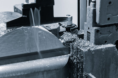 A machine is cutting a piece of metal. The metal is being cut into a circle. The machine is...