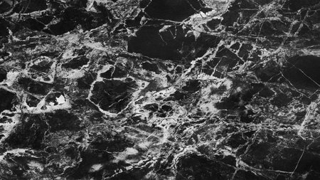 A black and white photo of a marble floor with a lot of cracks. The cracks are very visible and the...