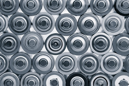 Closeup of pile of used alkaline batteries. Close up rows of selection of AA batteries energy...