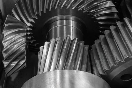A close up of a gear with many teeth. The gear is made of metal and is shinyの写真素材