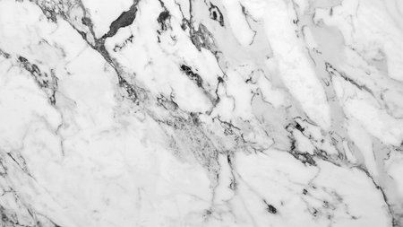 A white marble wall with a black and white pattern. The pattern is made up of small squares and circlesの写真素材