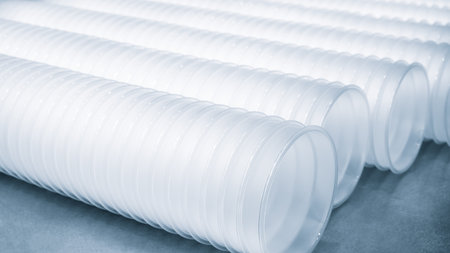 Three rows of white plastic cups are stacked on top of each other. The cups are all the same size...
