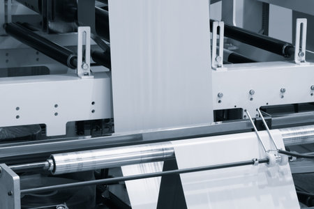 Automatic polyethylene plastic bag production machine with lighting effect. Close-up of the roller...