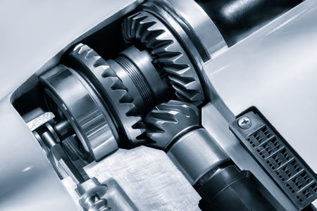 Close-up of a gear in black and silver color scheme. The gears are in the gearbox housing, the housing is open. Stripped down gearbox of a boat motor.の写真素材