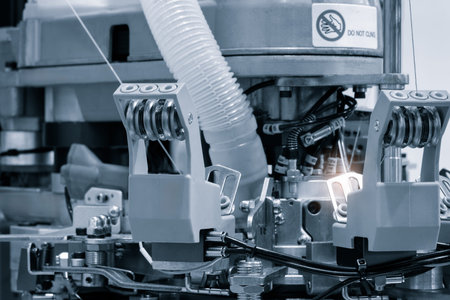 Industrial machine for embroidery of multi-colored threads on fabric