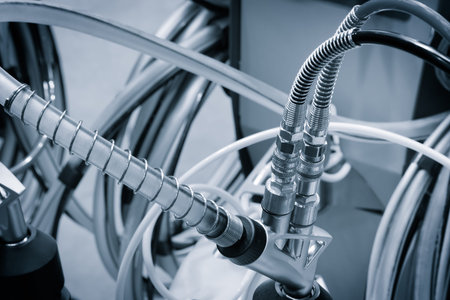 machine is connected to a hose with two connectors. The hose is black and silver industrial concept backgroundの写真素材