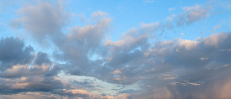 The sky is blue with a few clouds scattered throughout. The clouds are white and fluffy, giving the...