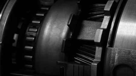 A dark black close up of a machine with many gears and discs. concept of powerful industrial energy of complexity and intricacy, and a sense of awareness at engineering behind machine.の写真素材