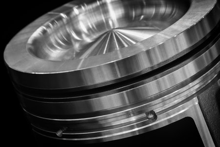 Dark black large piston engine. Piston new and shiny. Image has industrial and mechanical mood, service repair car concept backgroundの写真素材