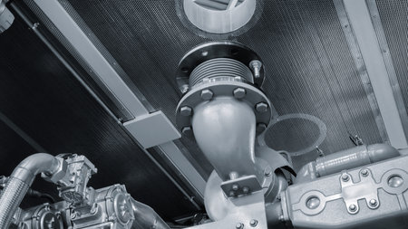 Large piston gas engine electric generator with many valves and pipes. The engine has many valves.