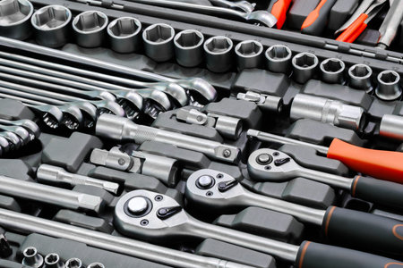 A toolbox with many tools including a wrench. The wrench is silver and has a black handle