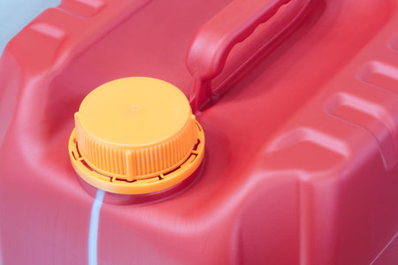 Plastic red canister, industrial packaging concept background