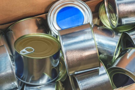 Box full of metal cans as background food production conceptの写真素材