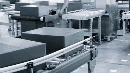 Cardboard boxes on conveyor belt of modern distribution logistics center, delivery logistics concept...