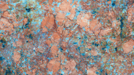 Close-up of a stone with a blue and red pattern. stone has a rough texture and is a type of granite. Abstract multicolor patterned textured background for a web banner.の写真素材