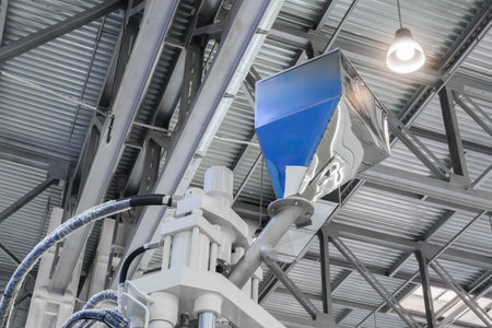 Large industrial PVC extrusion machine against industrial metal roof with lighting.
