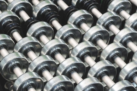 On the table there is a row of metal cylinders of rollers for industrial conveyor, industrial...
