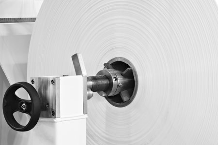 Automatic polyethylene plastic bag production machine with lighting effect. Close-up of the roller...